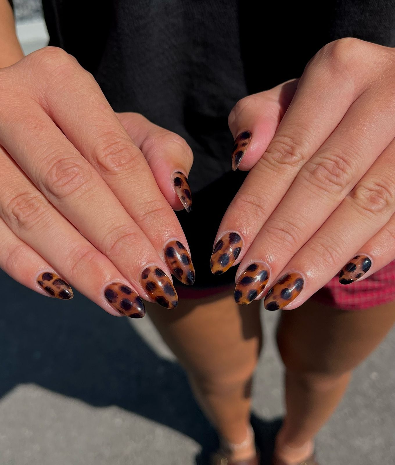 Close-up of hands with fall nail design having Tortoiseshell-Inspired Patterns