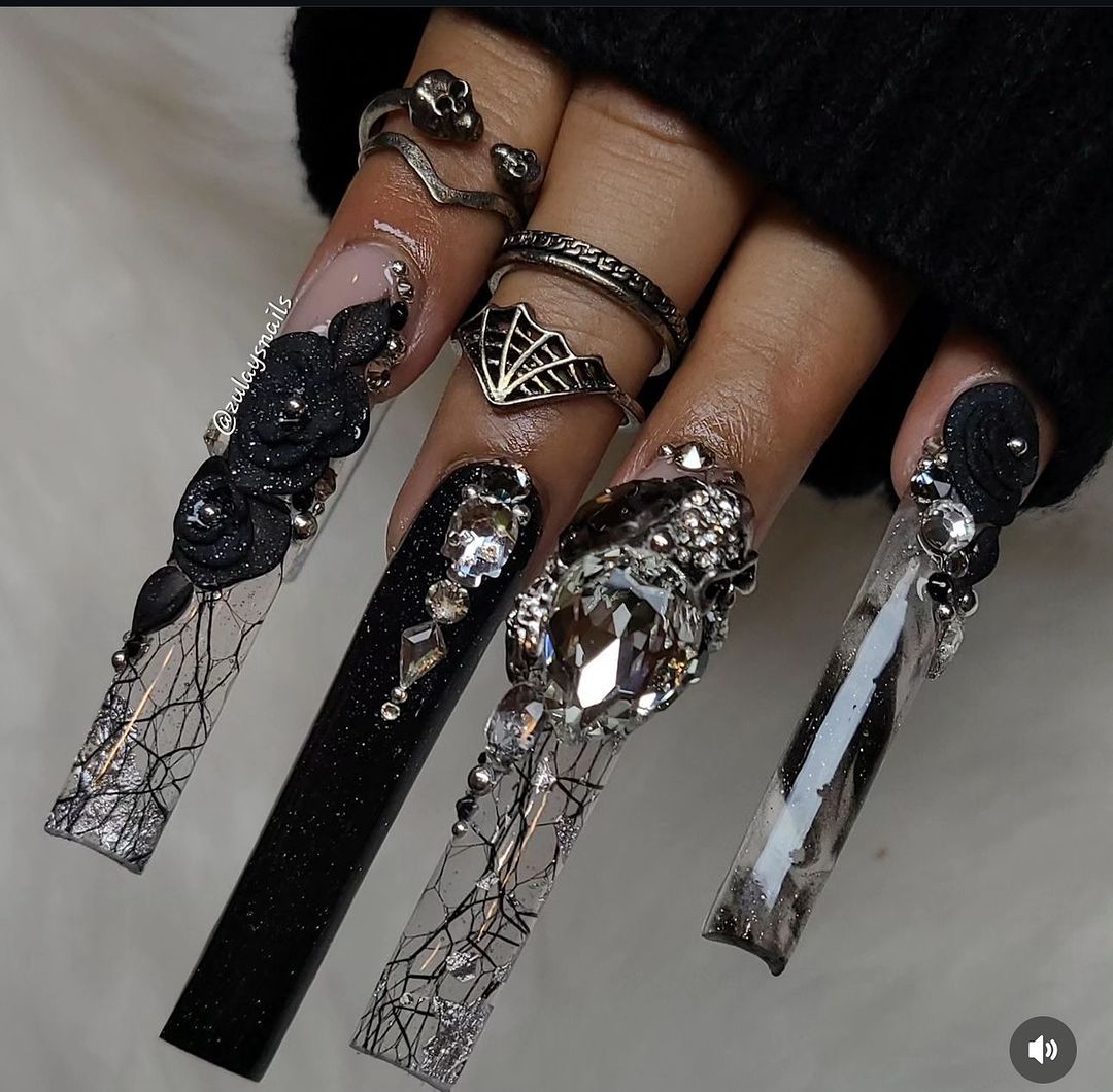 Close-up of a person's hands with black nails having Black Studs and Crystals