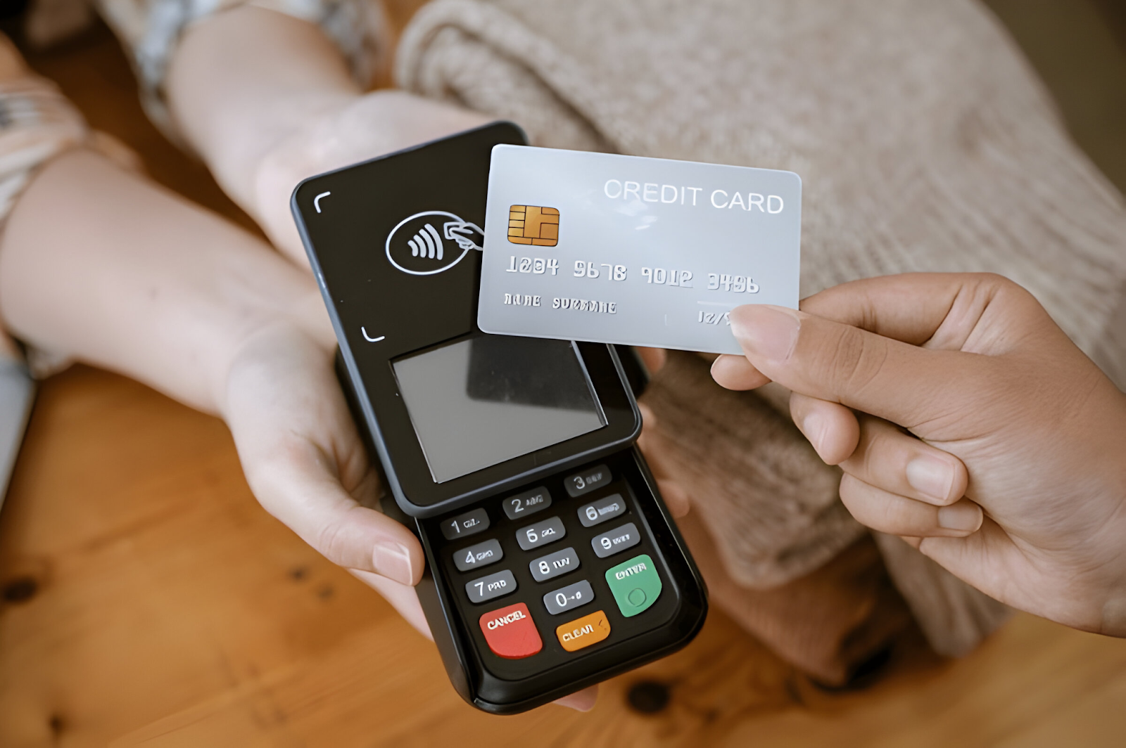 Close-up of a person using a credit card machine for payment, symbolizing the follow-up process on overdue payments in accounts receivable.