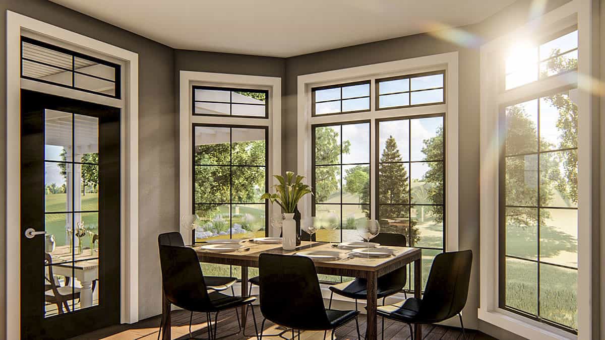 Breakfast nook with a bay window and a glazed door that opens onto a covered patio.