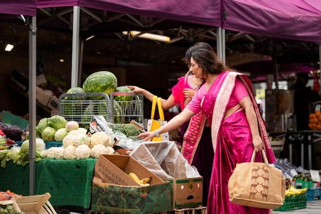 Side view women shopping for groceries