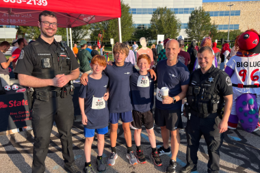benefits of hiring local kitchen remodel contractors remodeler taking picture with police officers at fundraiser custom built michigan