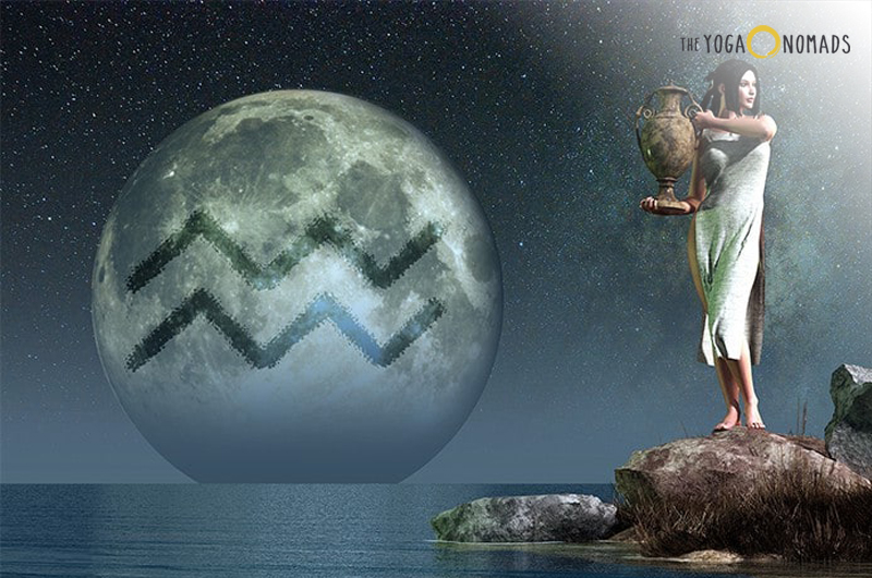 A digital artwork showing an individual standing on a rock by the sea, pouring water from a vessel into the sea under a large moon with visible craters. The moon occupies a significant portion of the sky, suggesting it is either very close or unusually large. In the upper right corner, there is text that reads ‘THE YOGA NOMADS’.