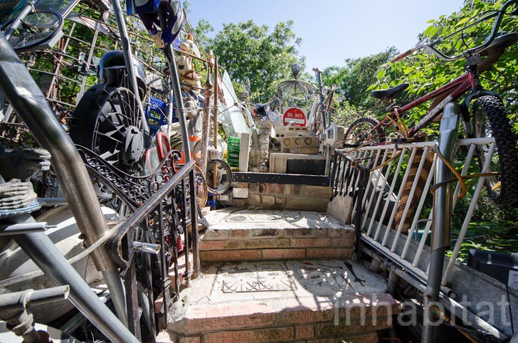 Staircase inside the Cathedral of Junk, surrounded by a whimsical arrangement of recycled materials.