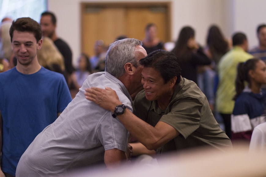 Two men hugging in focus photography