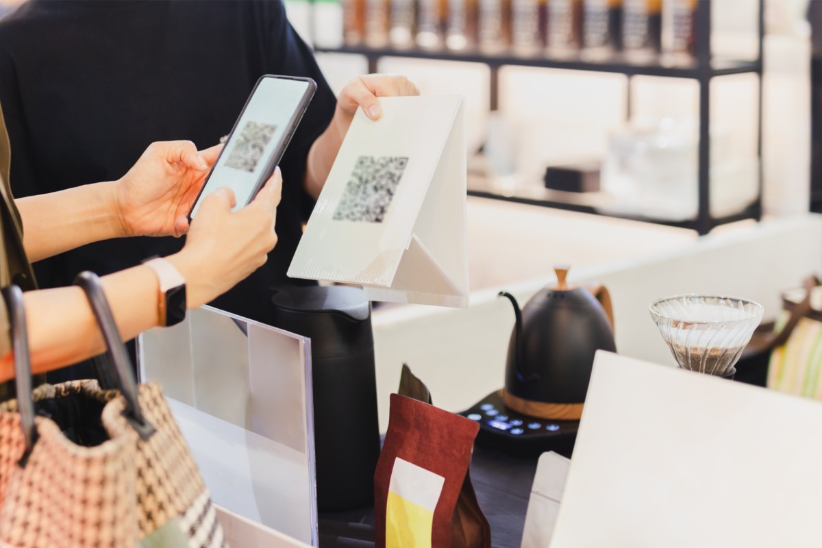 Close-up of a customer scanning a QR code for seamless checkout.