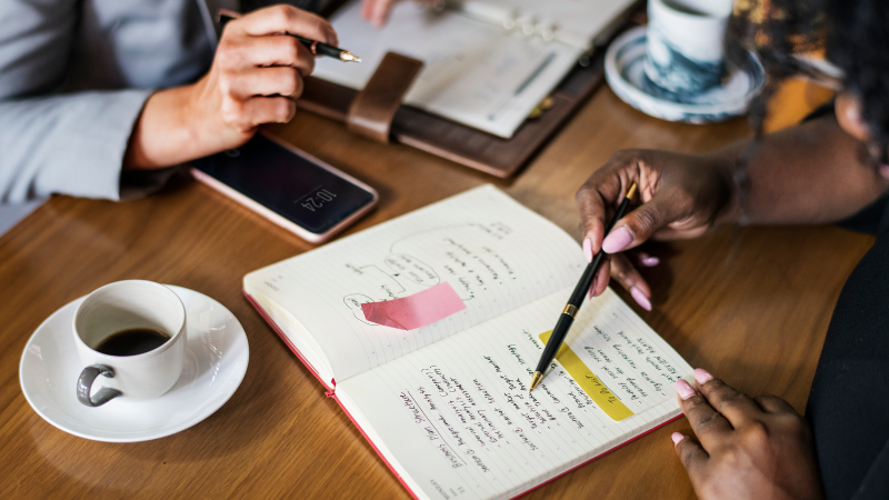 People discussing meeting notes