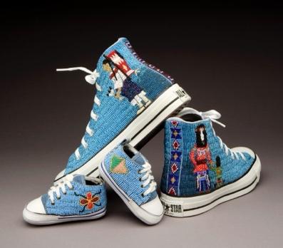 A pair of blue shoes with embroidered designsDescription automatically generated