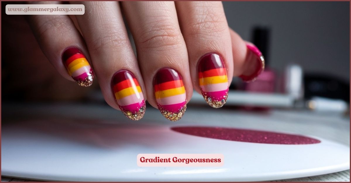 Multicolored ombre nail art with gold glitter tips on a hand above a magazine.