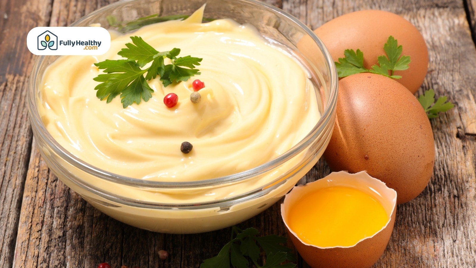 Mayonnaise in bowl with parsley pepper and raw eggs beside it