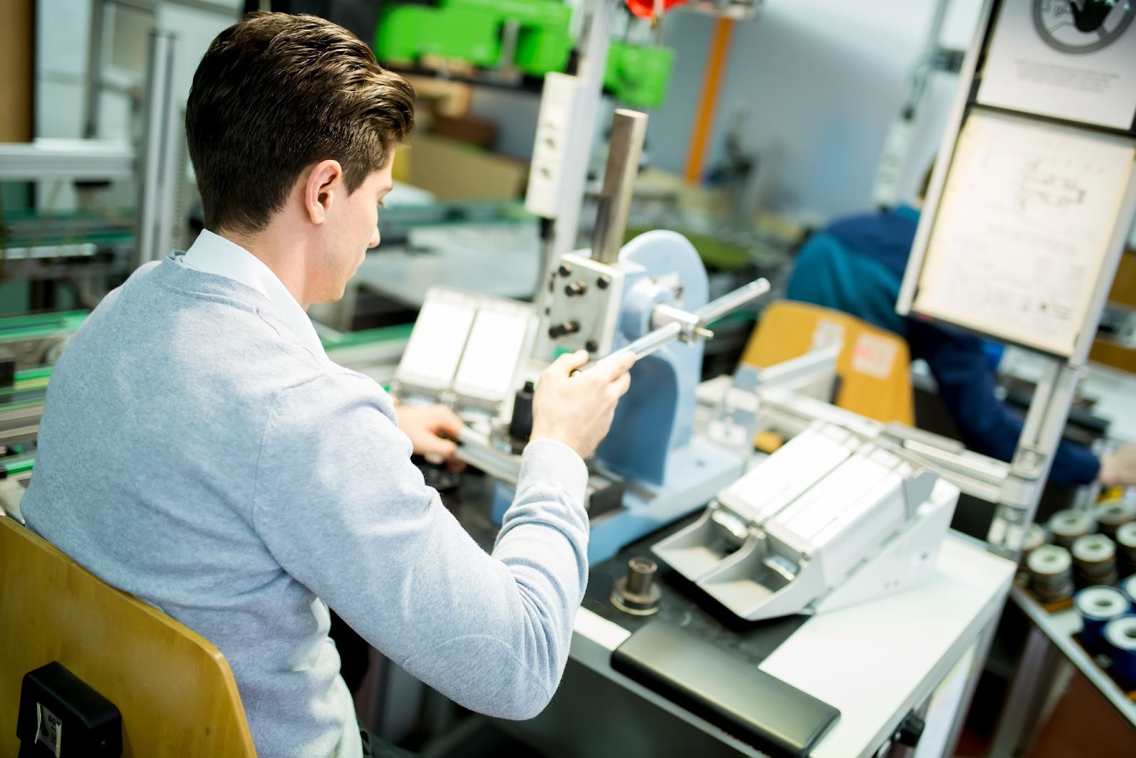 A man working on prototype development using an advanced machines