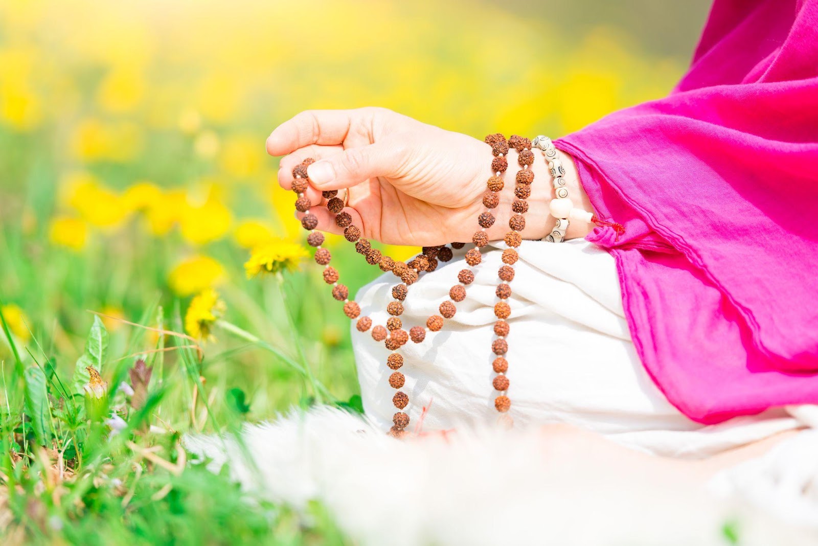 Hand holding prayer beads