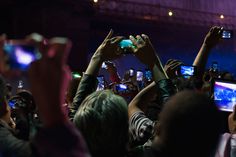 This is a picture of people in crowd operating their phones