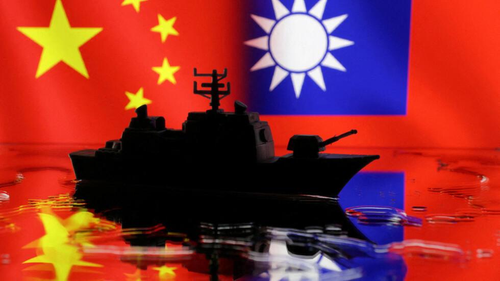 A Navy miniature is seen in front of displayed Chinese and Taiwanese flags in this illustration taken, April 11, 2023.