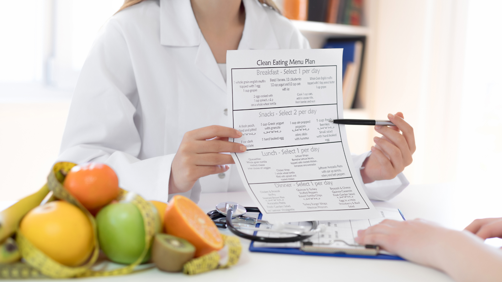 Dietitian holding a eating plan while pointing with a pen // Healthier Veterans Today