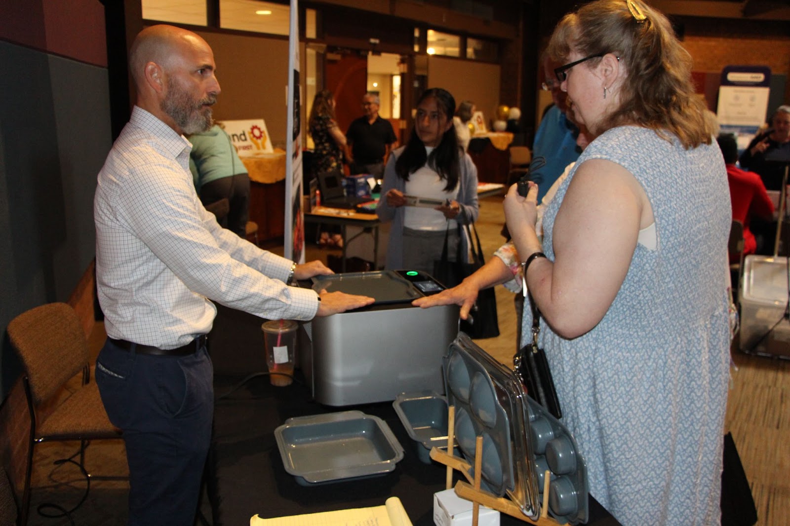 An attendee speaks with a vendor during the Technology First event. 