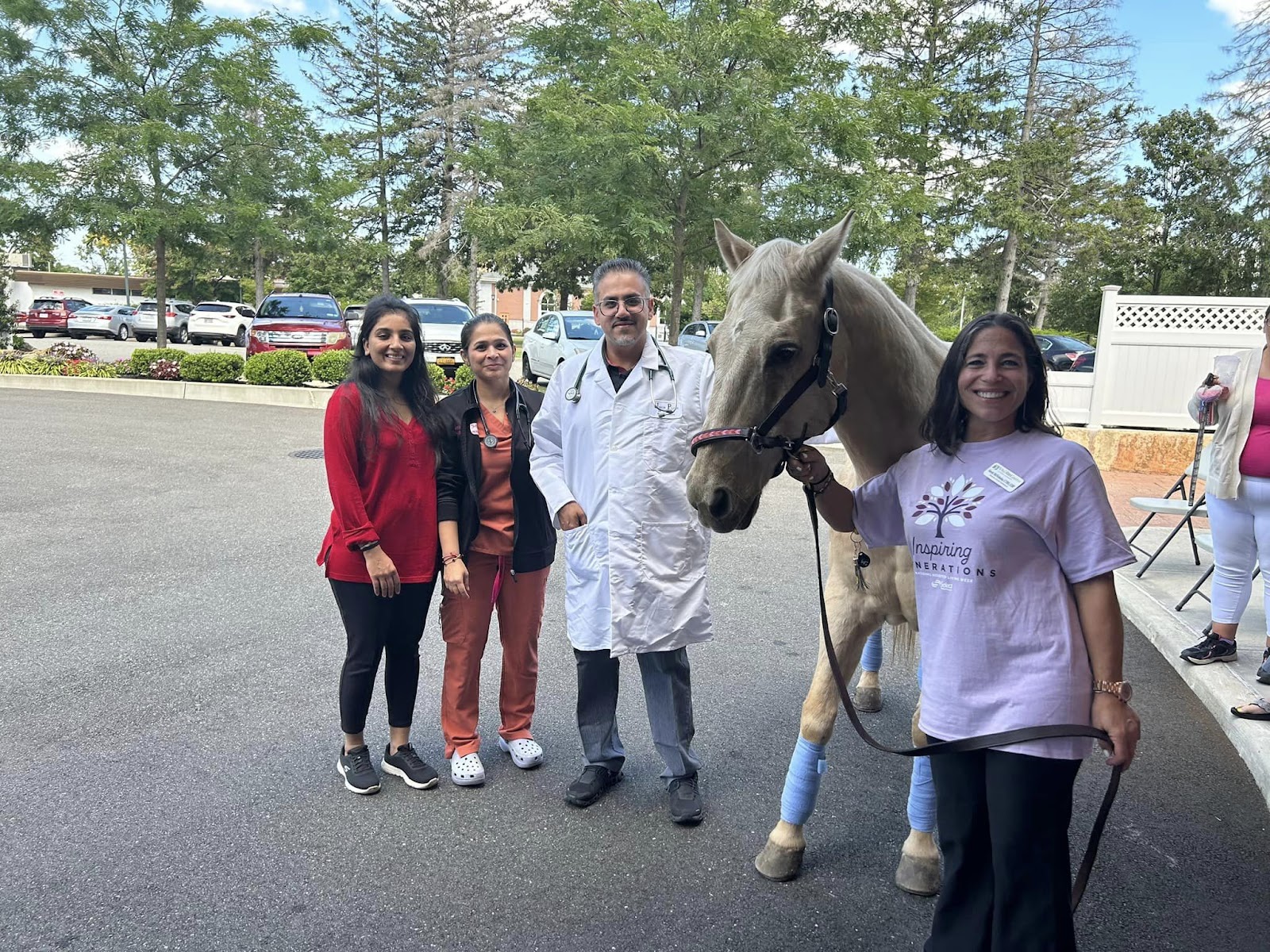 A picture of a horse, doctor, and other people in the background at a memory care community