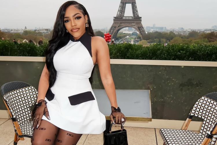 A girl in a white birthday dress celebrating in France in front of the Eiffel Tower, Paris.