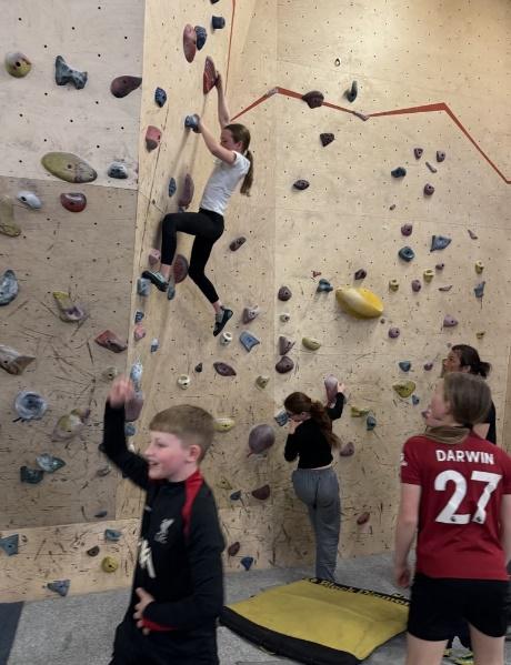 A group of people climbing a rock wall
AI-generated content may be incorrect.