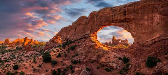 A large rock formation with a hole in the middle

AI-generated content may be incorrect.