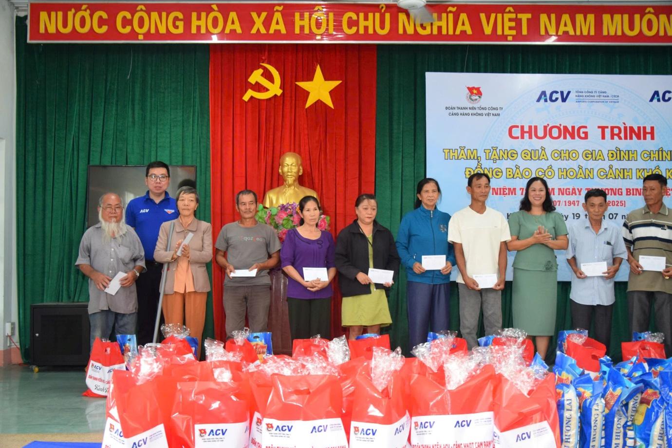 A group of people standing in front of a stage with red bagsAI-generated content may be incorrect.