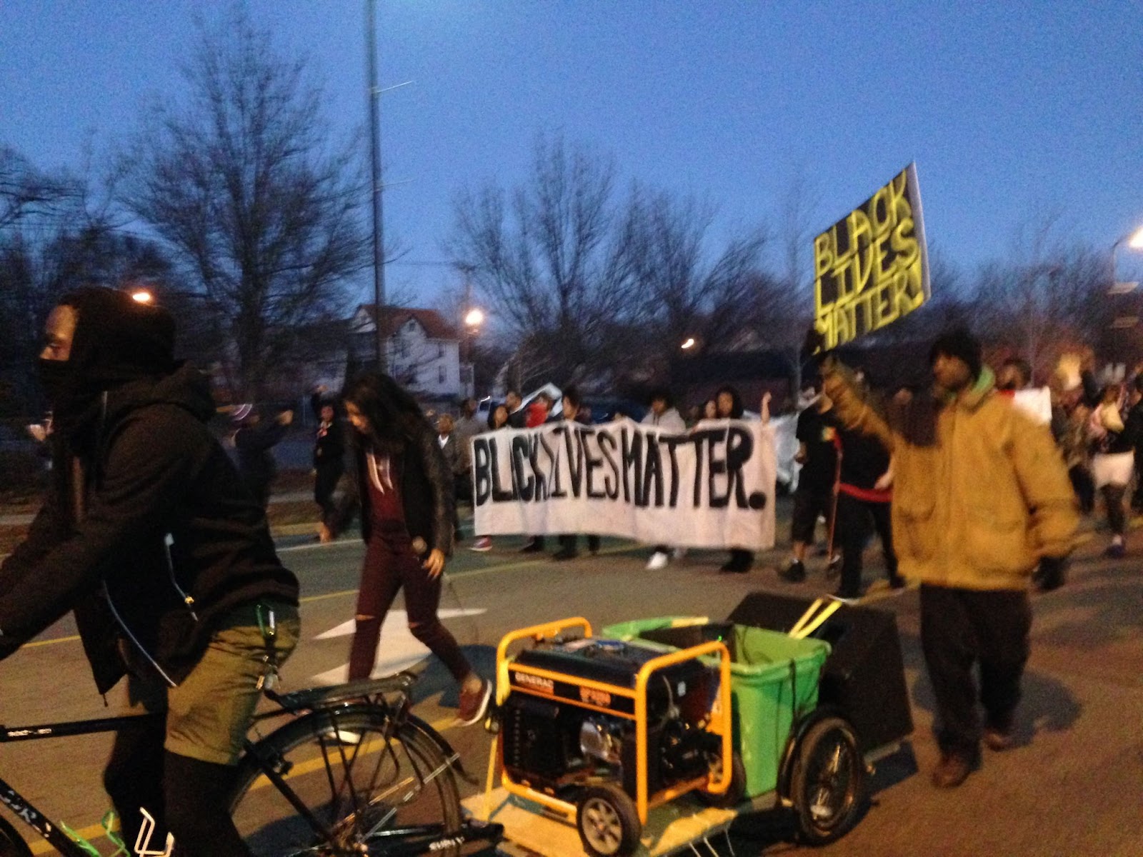 Image: Activists marching down Plymouth Ave during the Jamar Clark occupation, 2015. Many hold signs that say, "BLACK LIVES MATTER". Photo by the author.