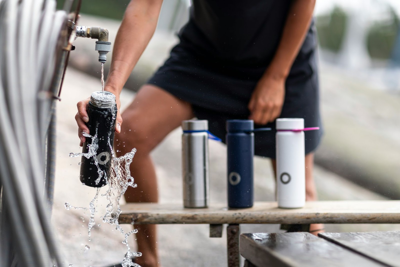 A man fills his water bottle for his rented electric bike ride in Paris.