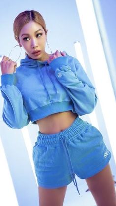 This contains an image of: jessi on a blue short and a crop hoodie top