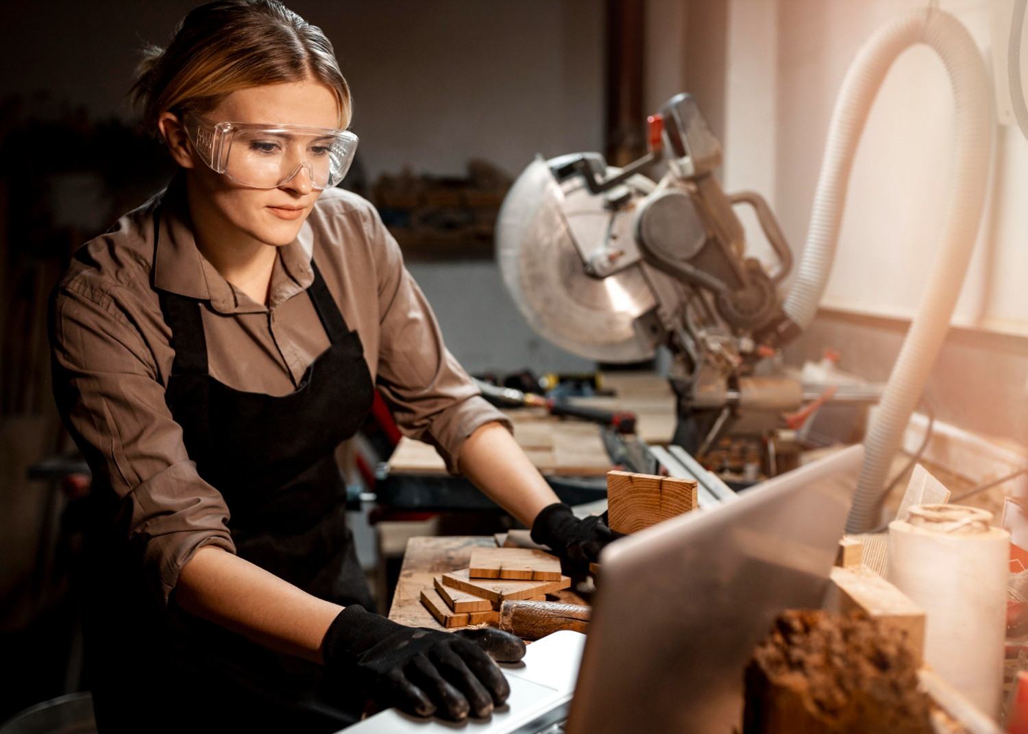 A woodworker stands at a higher ergonomic workbench.