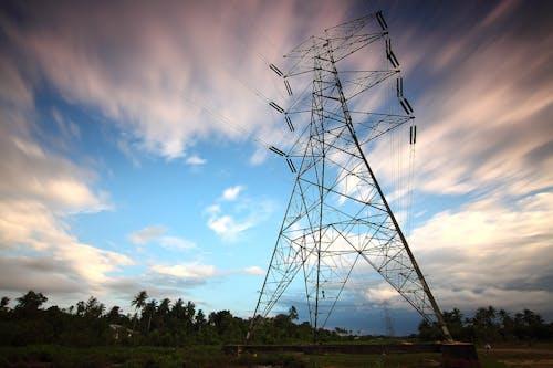 Free Stunning view of a towering power line against a vibrant sky, showcasing energy infrastructure in nature. Stock Photo