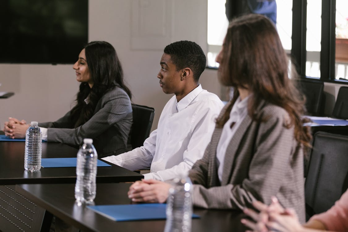 Employees attending a compliance and soft-skills training session using corporate training methods