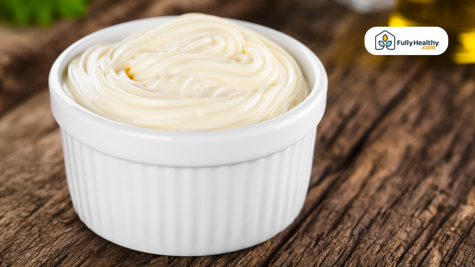 Creamy mayonnaise in a white ramekin on rustic wooden surface