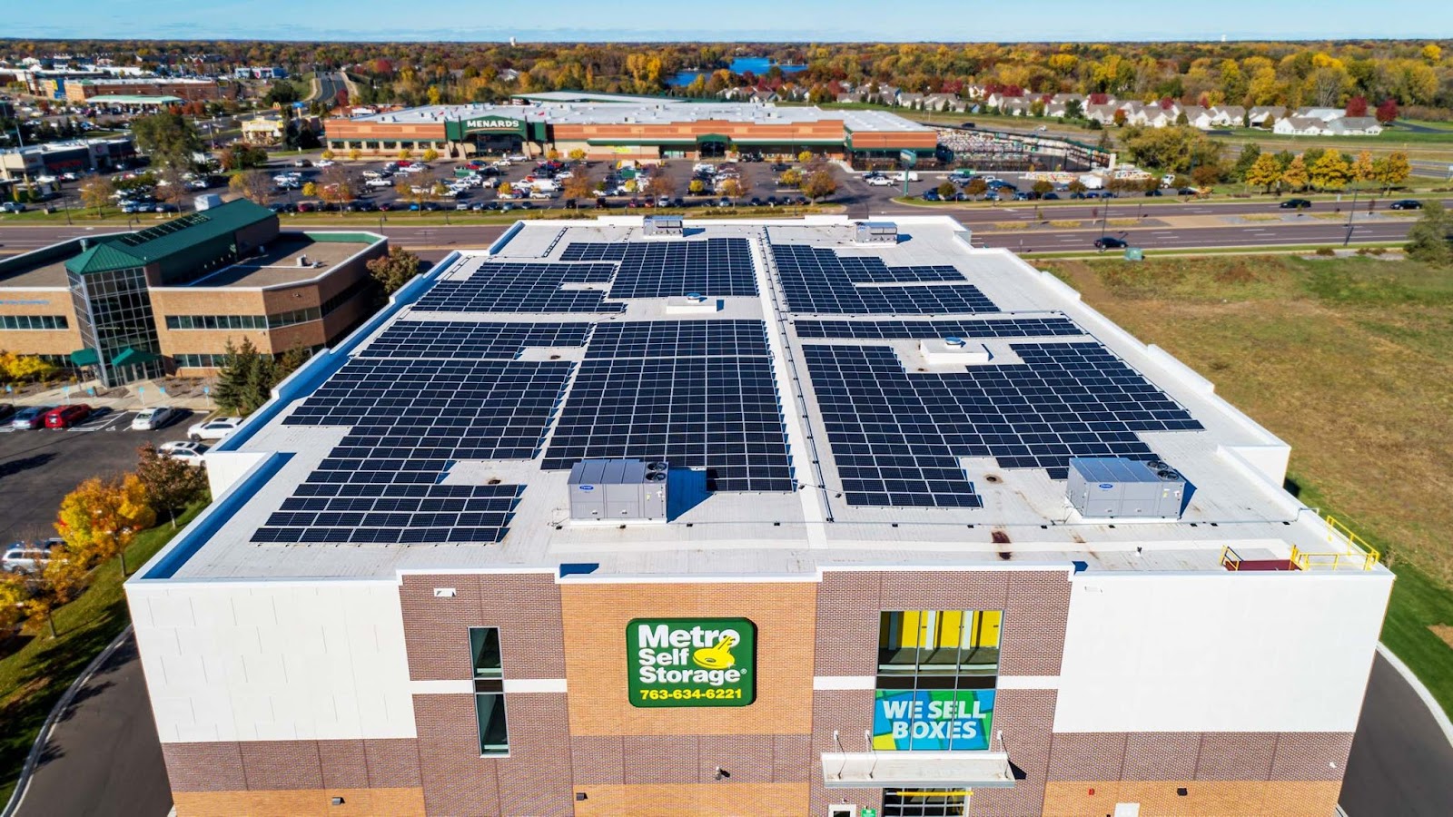 Drone view of the top of a Metro Self Storage facility with solar panels on the roof. 