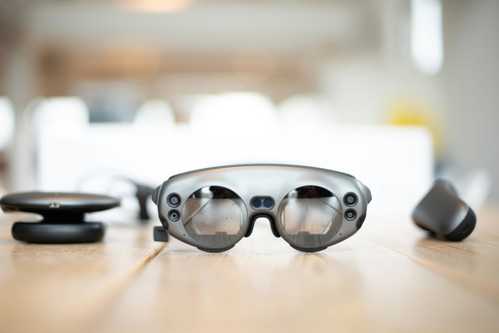 Grey AR glasses and peripherals on a table.
