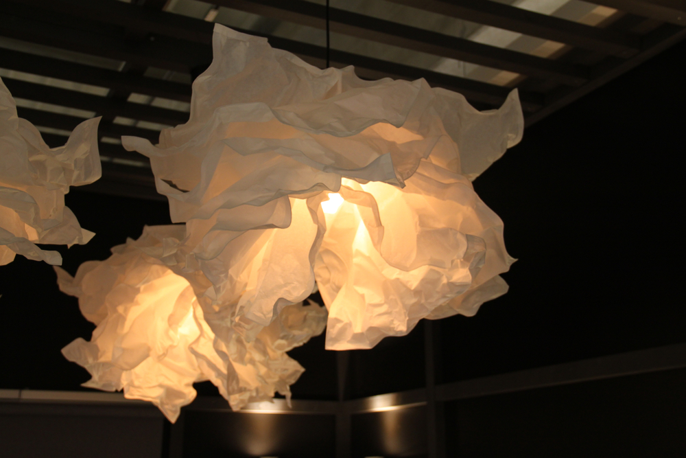 A lamp with a paper lampshade.