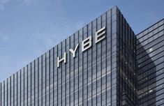 This contains an of hybe logo is on top of an office building