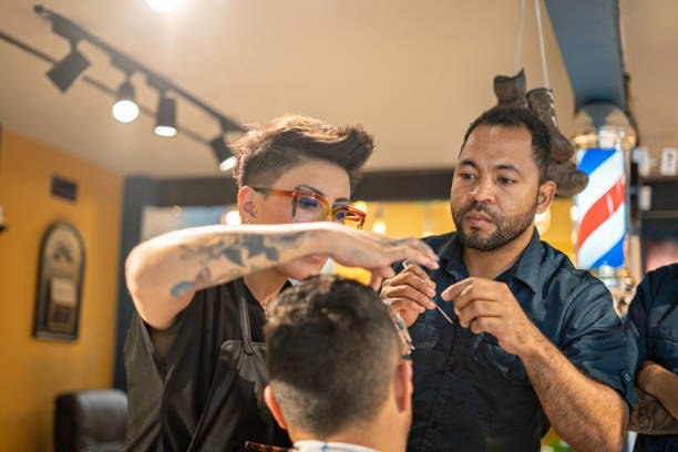 A student practicing haircutting techniques in a basic barbering course designed for beginners.