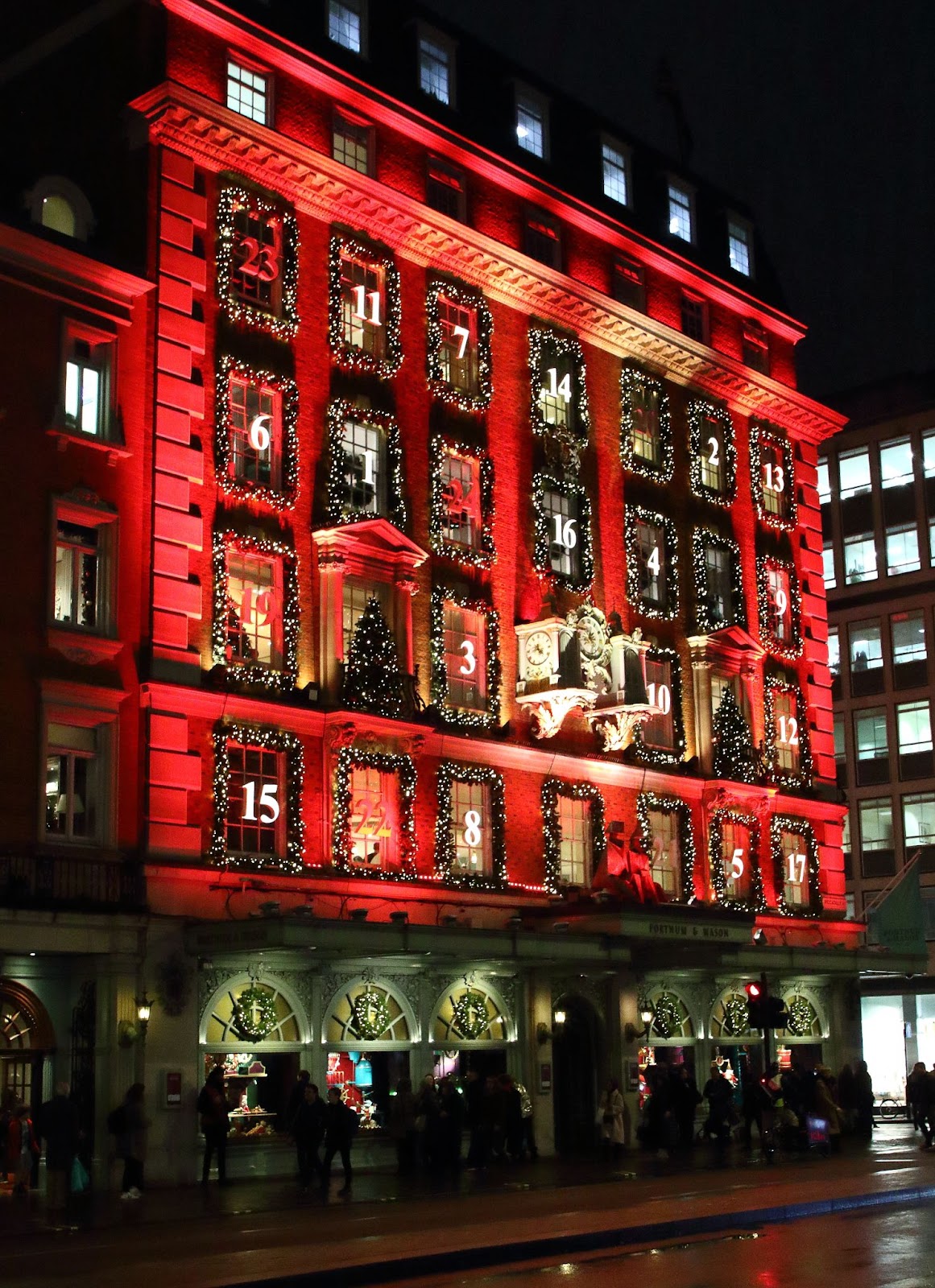 Festive Christmas window display at Fortnum & Mason, an iconic department store in London, showcasing holiday decorations and seasonal gifts