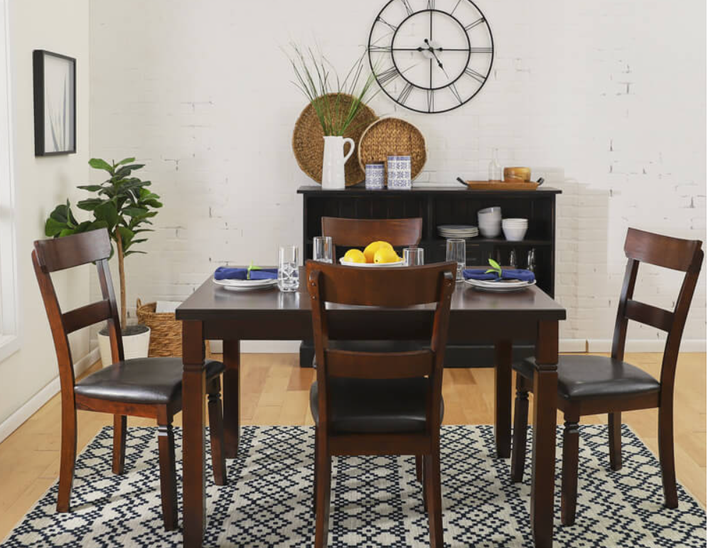 A dining table with chairs and a clock on the wall

Description automatically generated