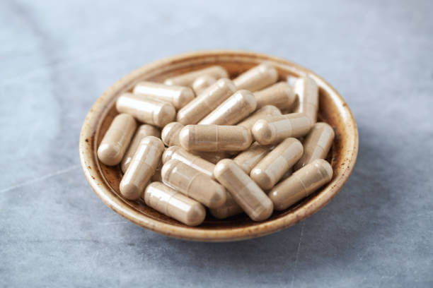 Ashwagandha supplements in a ceramic saucer.