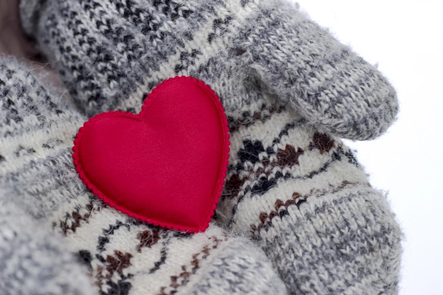 A heart shaped object on a person's hand

Description automatically generated