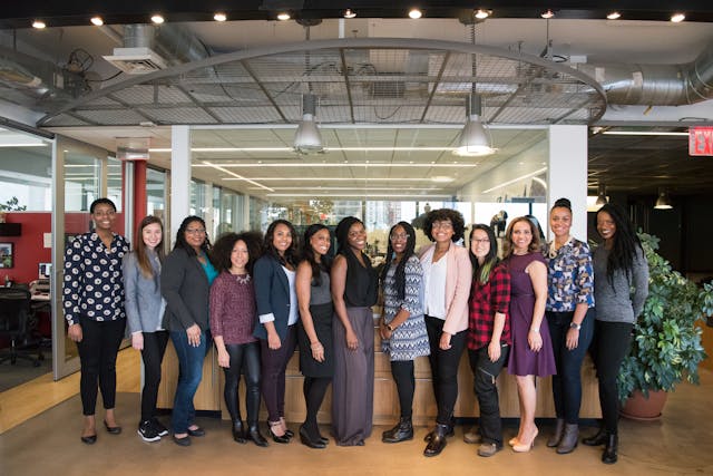  A group of women standing near a desk