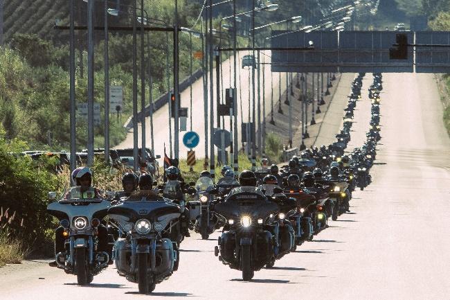 May be an image of 3 people, motorcycle and road