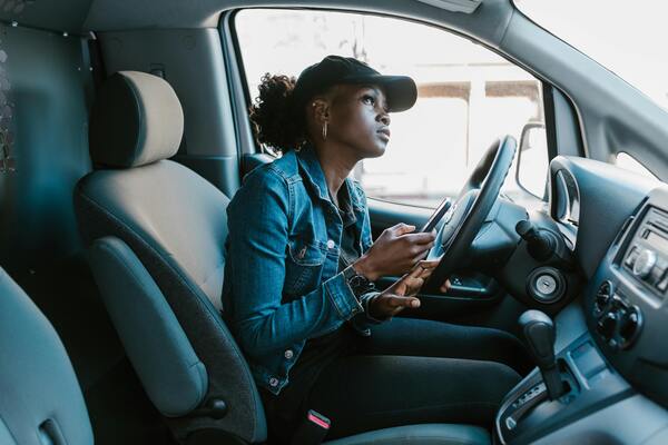 DPD courier van driven by a young female driver, representing modern, accessible logistics and pick-up point services.