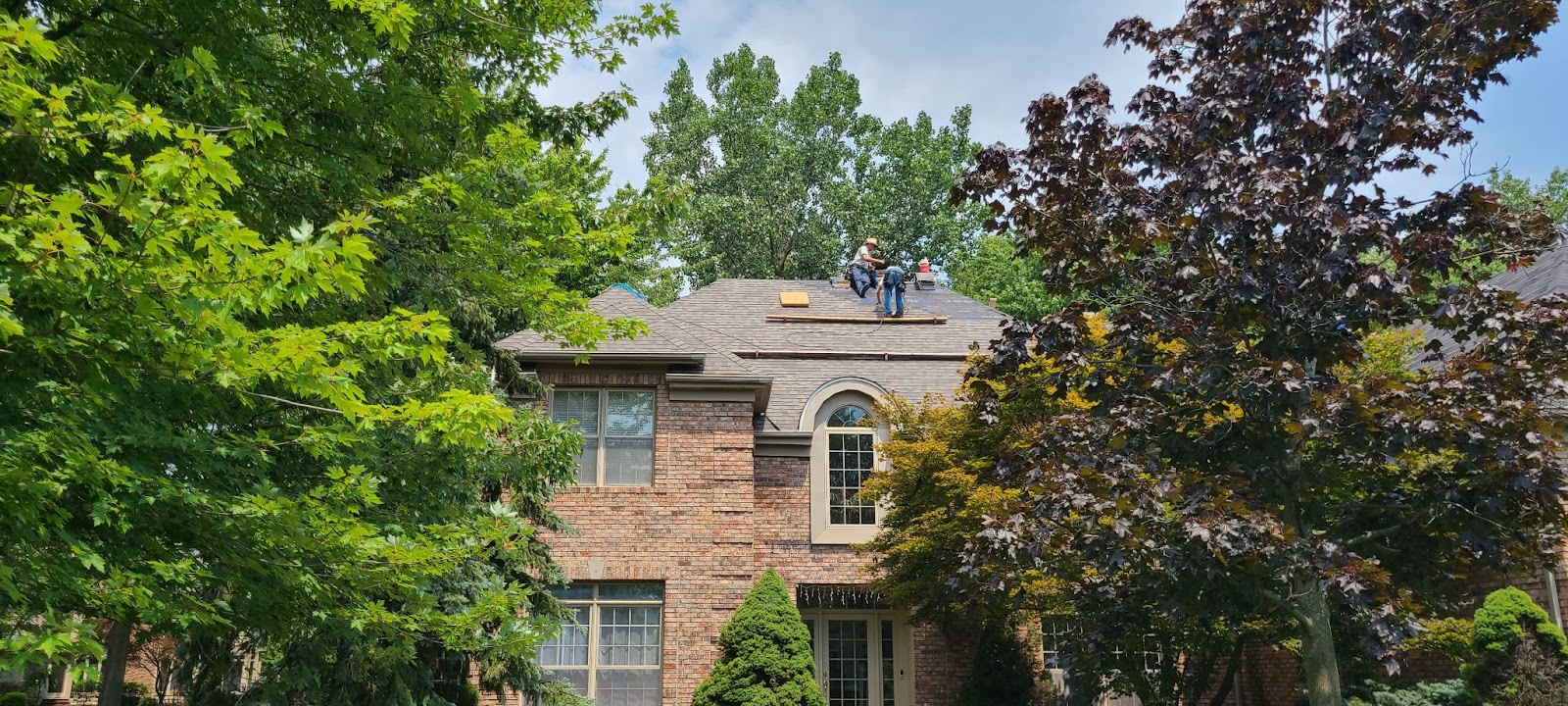 a roofing contract in Orange, OH installs a new roof on a two story home