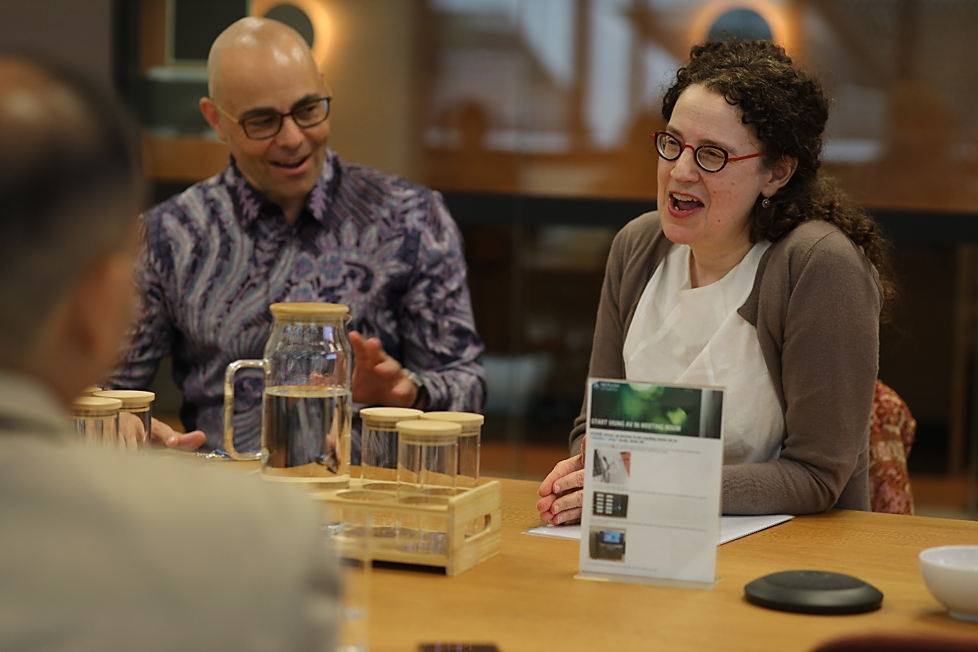 A group of people sitting at a table

AI-generated content may be incorrect.