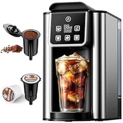 Iced coffee being brewed in a Keurig machine, with a glass filled with ice cubes. K-Cups and a reusable coffee filter are displayed next to the machine.