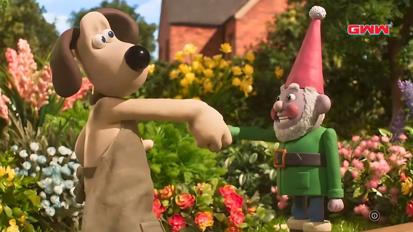 Gromit shaking hands with a gnome in a colorful garden.