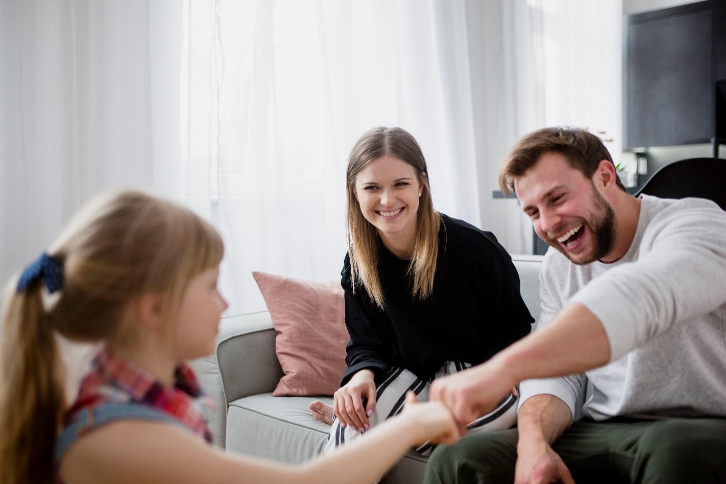 A group of people sitting on a couch

Description automatically generated