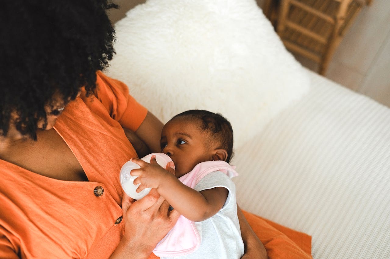 Mom feeding her baby with bottle // Healthier Baby Today